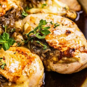 close up of french onion stuffed chicken in a pot.