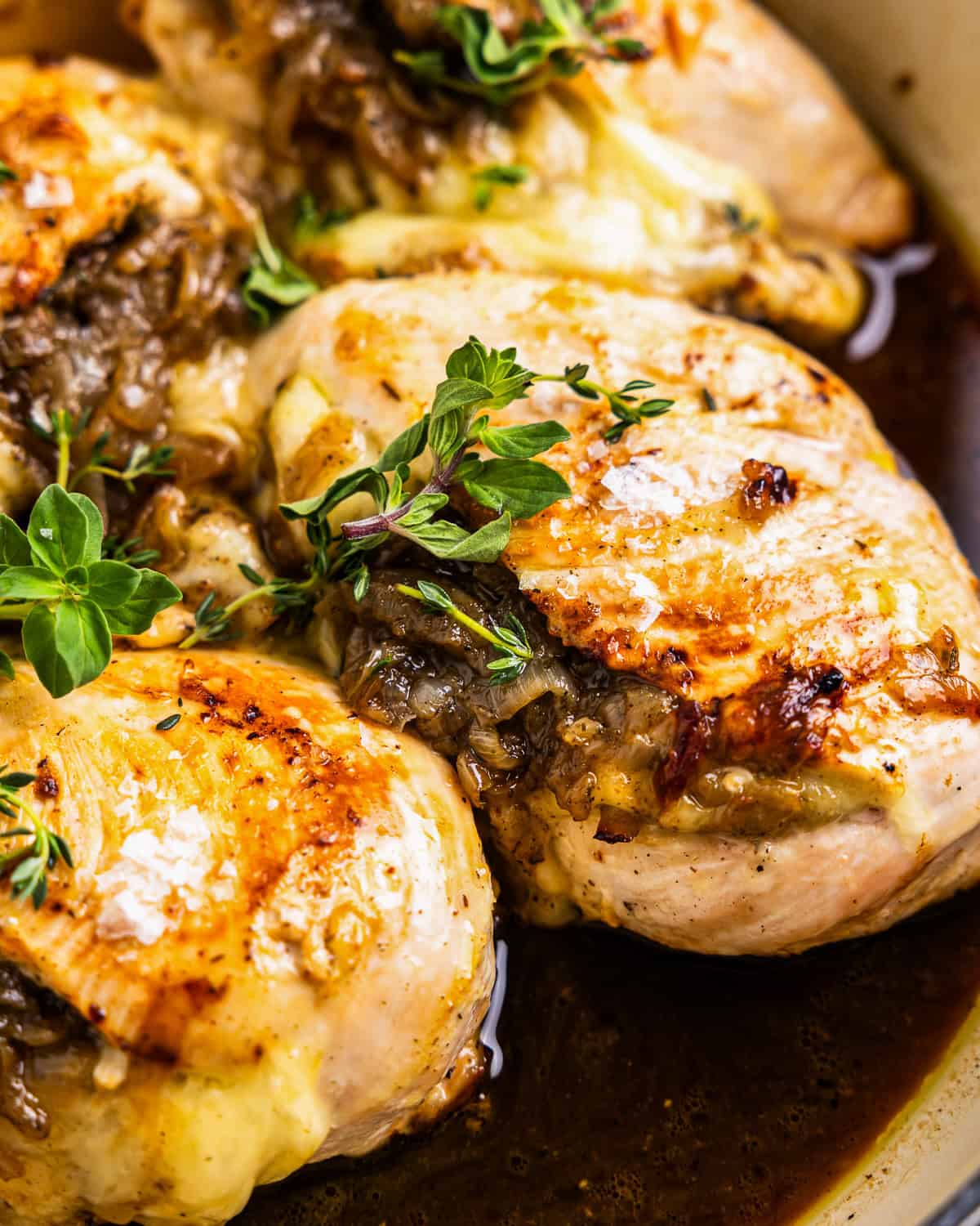 close up of french onion stuffed chicken in a pot.