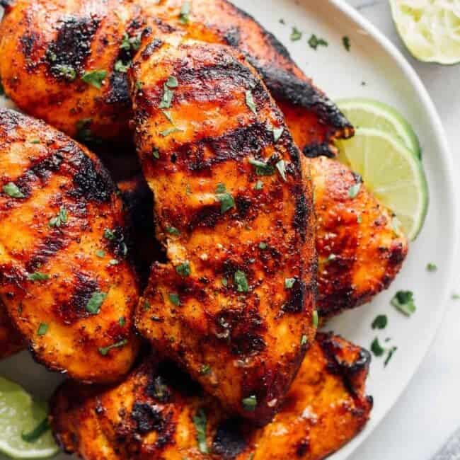 white plate topped with grilled chicken breasts