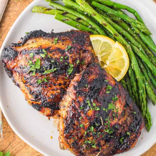 plate of grilled chicken thighs with asparagus