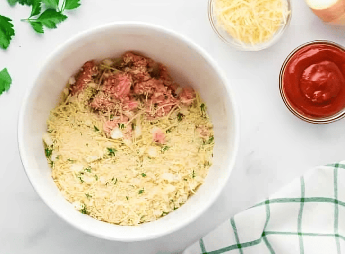 ground chicken and seasoned breadcrumbs in a white bowl.