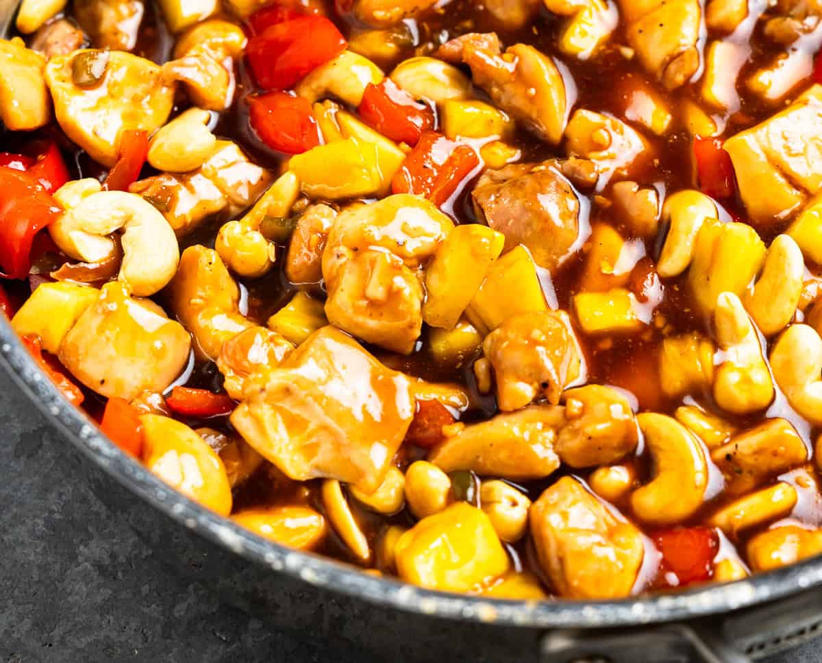 saucy pineapple chicken in a pan.