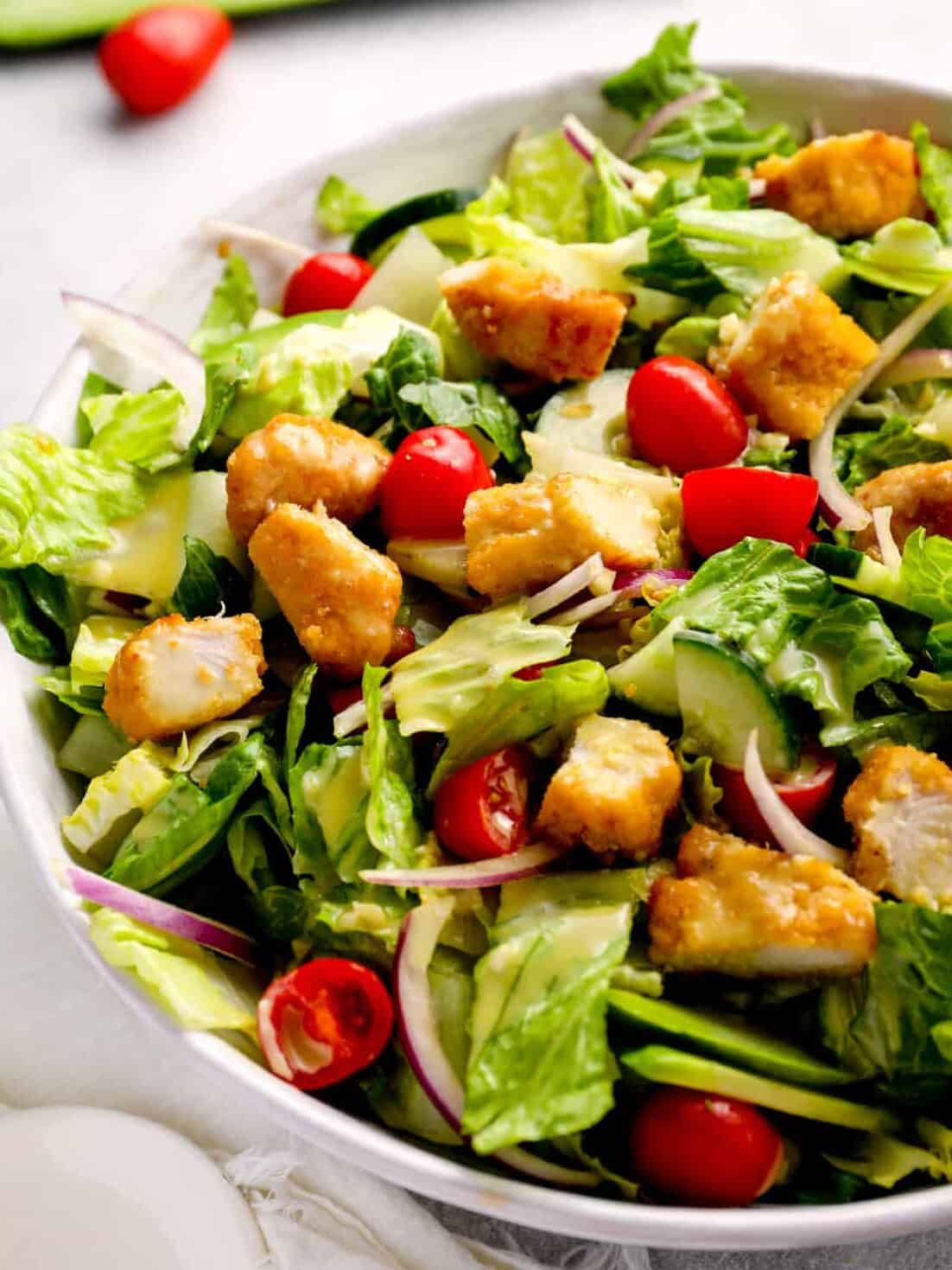 salad tossed with tomatoes, onions, croutons, and more