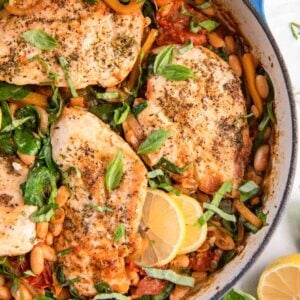 overhead partial close-up view of italian chicken skillet in a blue cast iron pan.