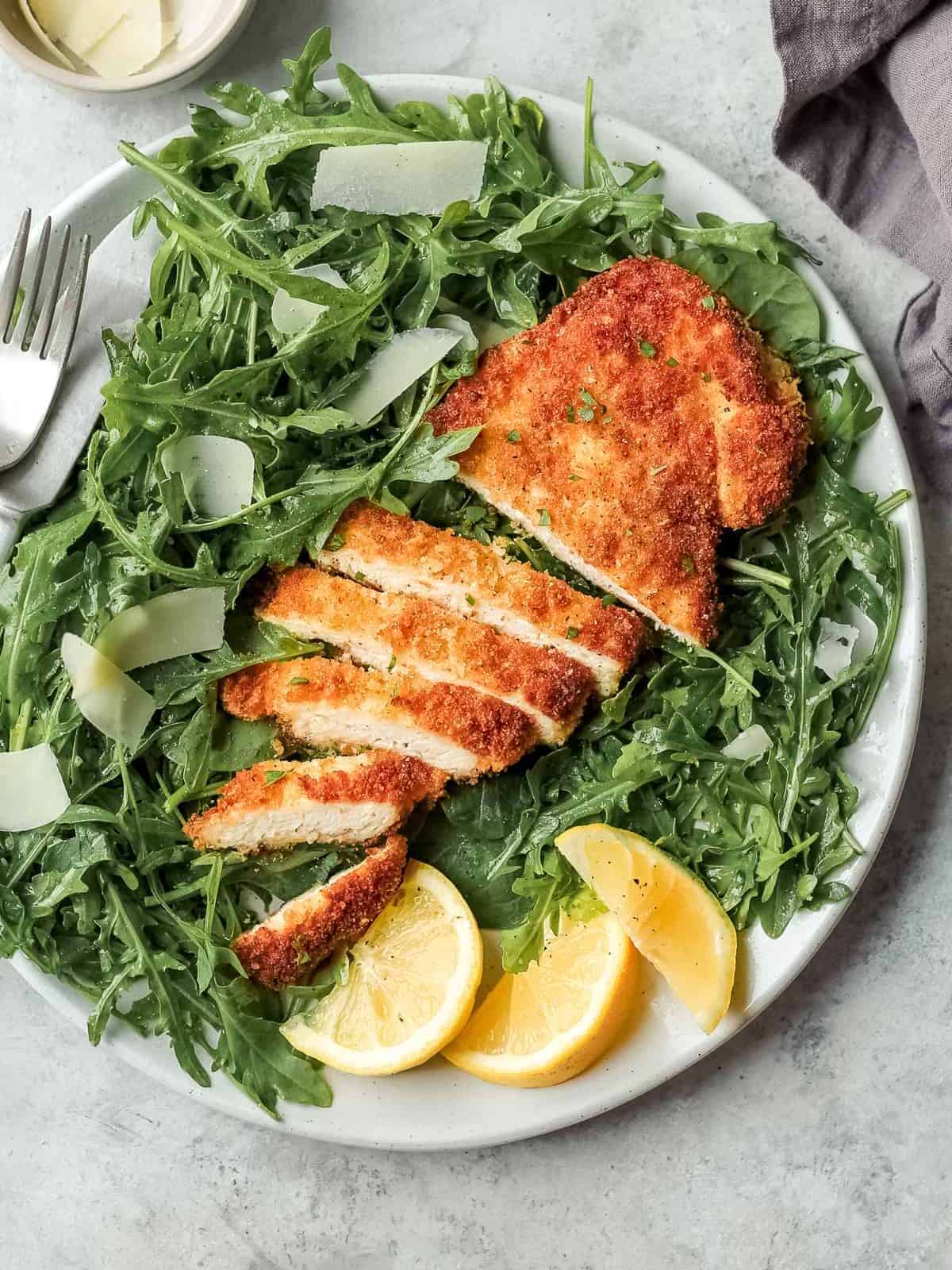 chicken milanese on plate with salad