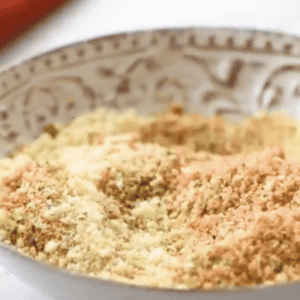 seasoned breadcrumbs in a white dish.