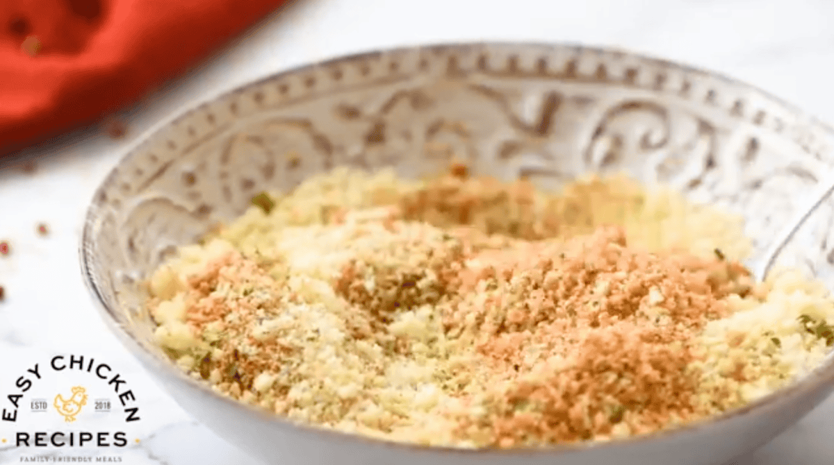 seasoned breadcrumbs in a white dish.