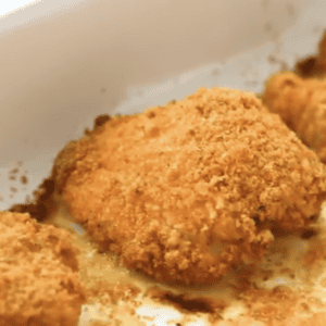 parmesan crusted chicken in a baking dish.