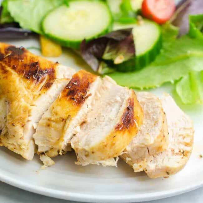 Grilled sous vide chicken breast served with a salad.