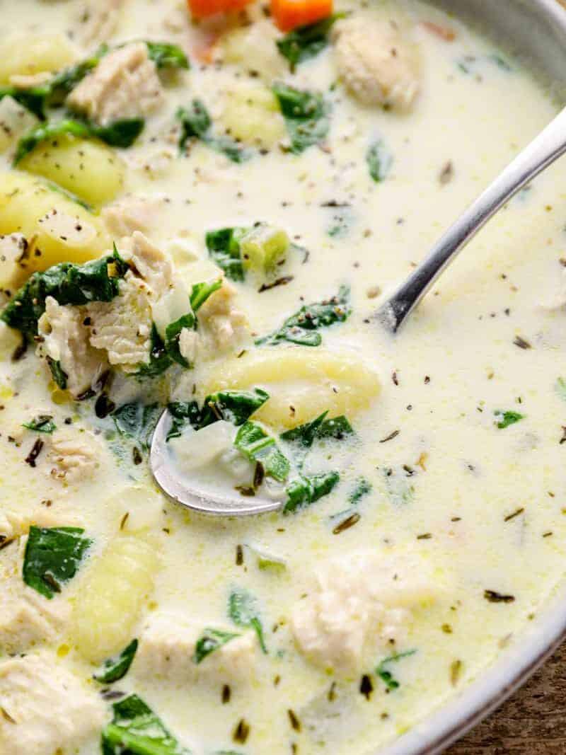 chicken gnocchi soup in a bowl with a spoon