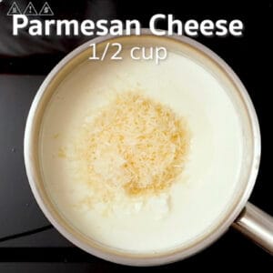 adding shredded parmesan cheese to cream sauce in a saucepan overlaid with text "parmesan cheese 1/2 cup".