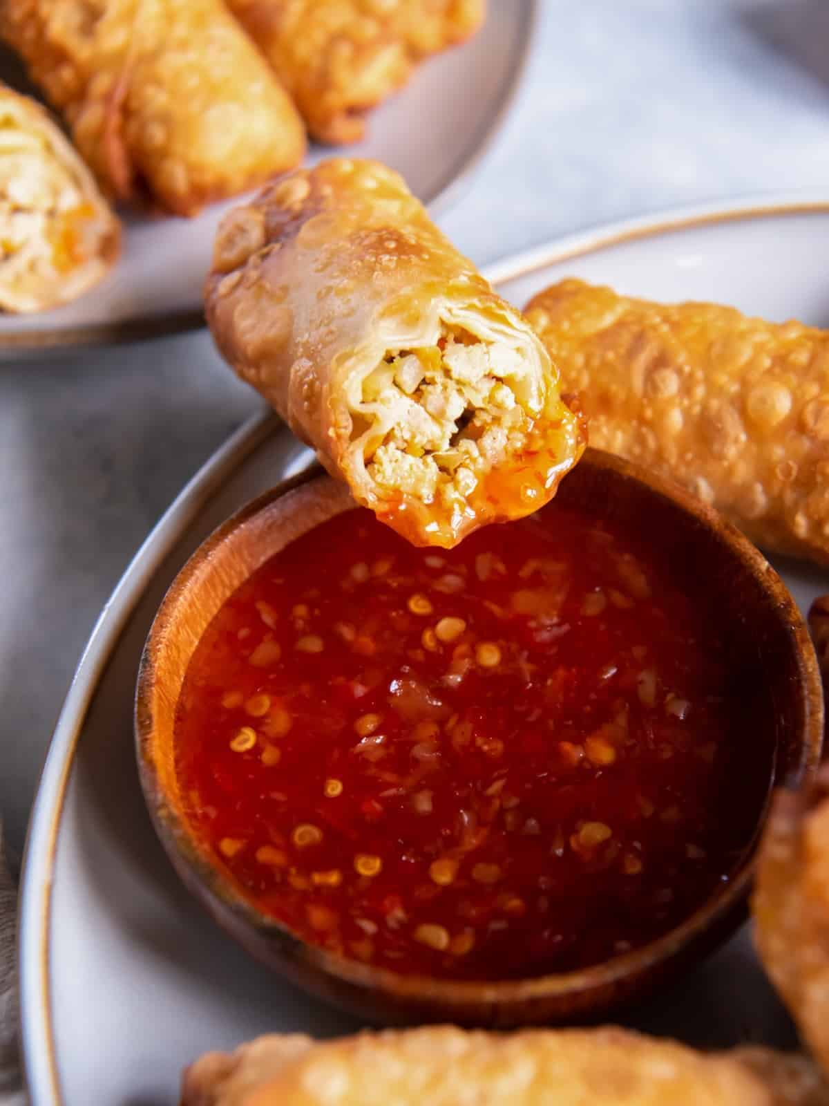egg rolls dipped in sauce