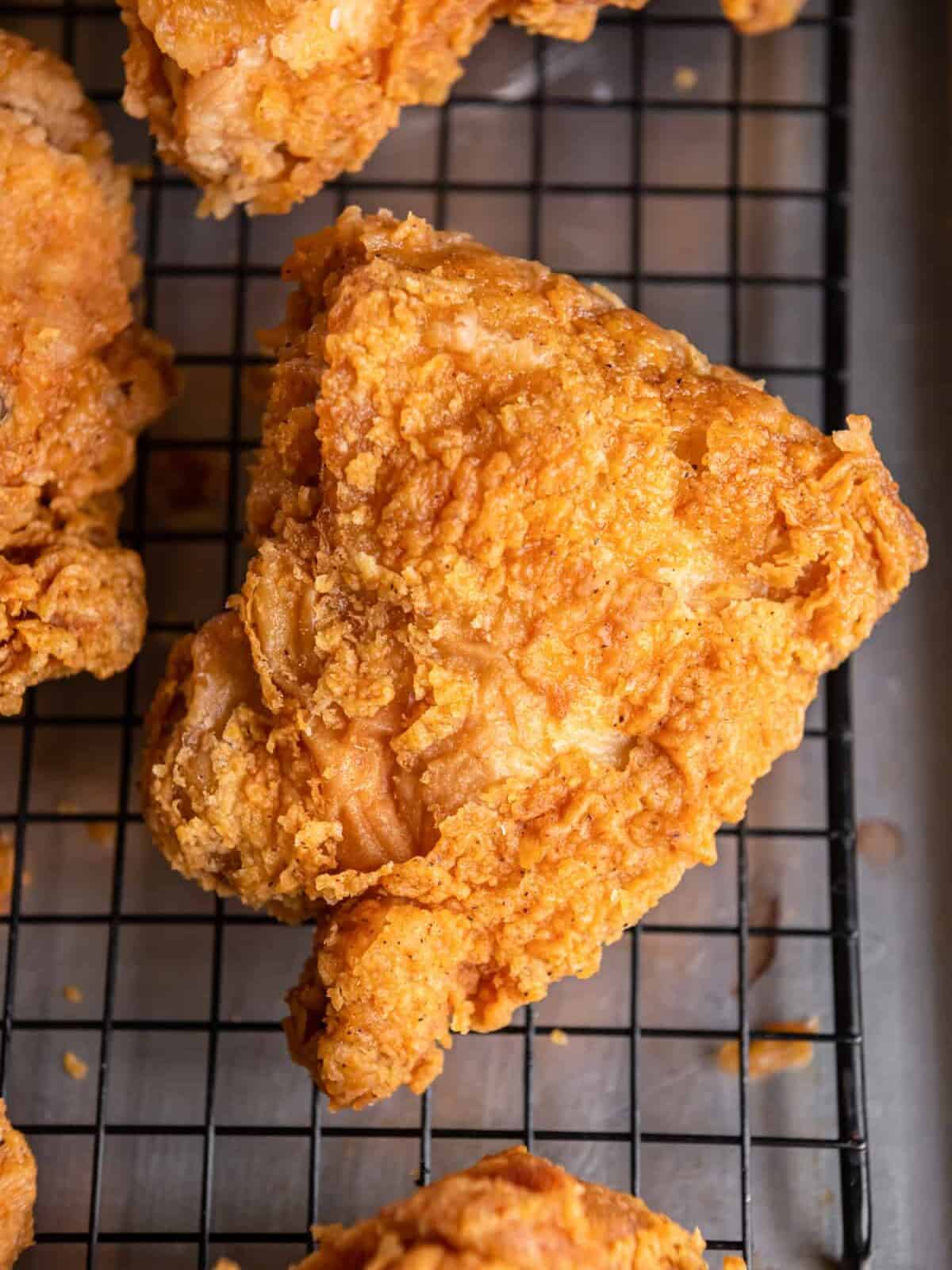 Kentucky fried chicken thigh on a cooling rack