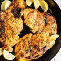 pan fried chicken breasts with lemon wedges