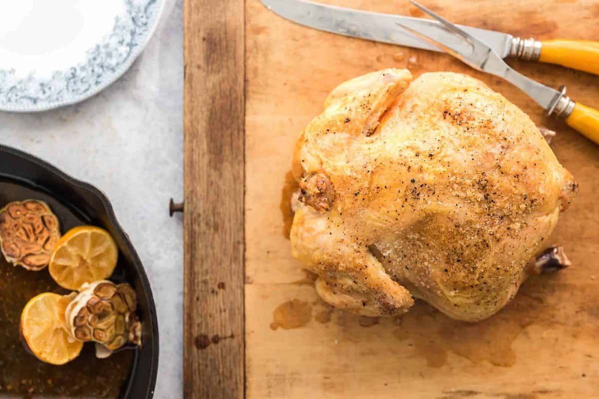 whole roasted chicken on cutting board