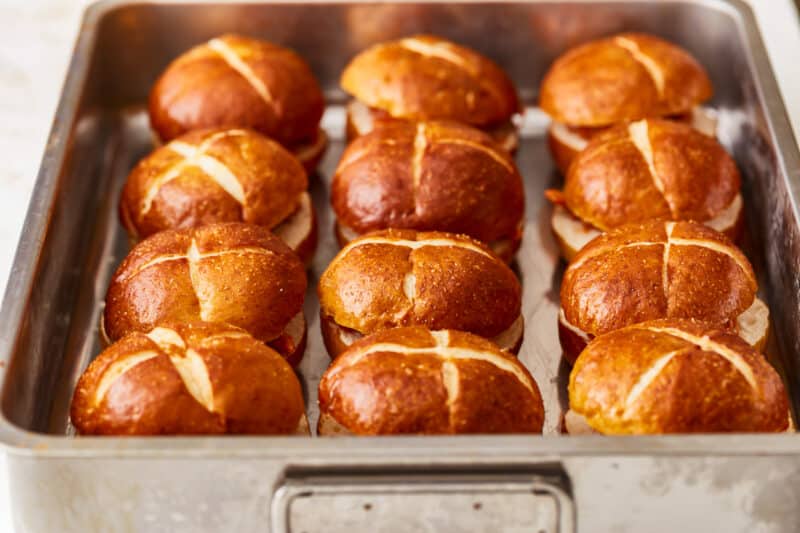 Hot cross buns in a baking pan.