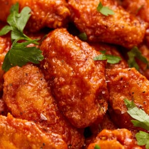 Bbq chicken wings in a bowl with parsley.