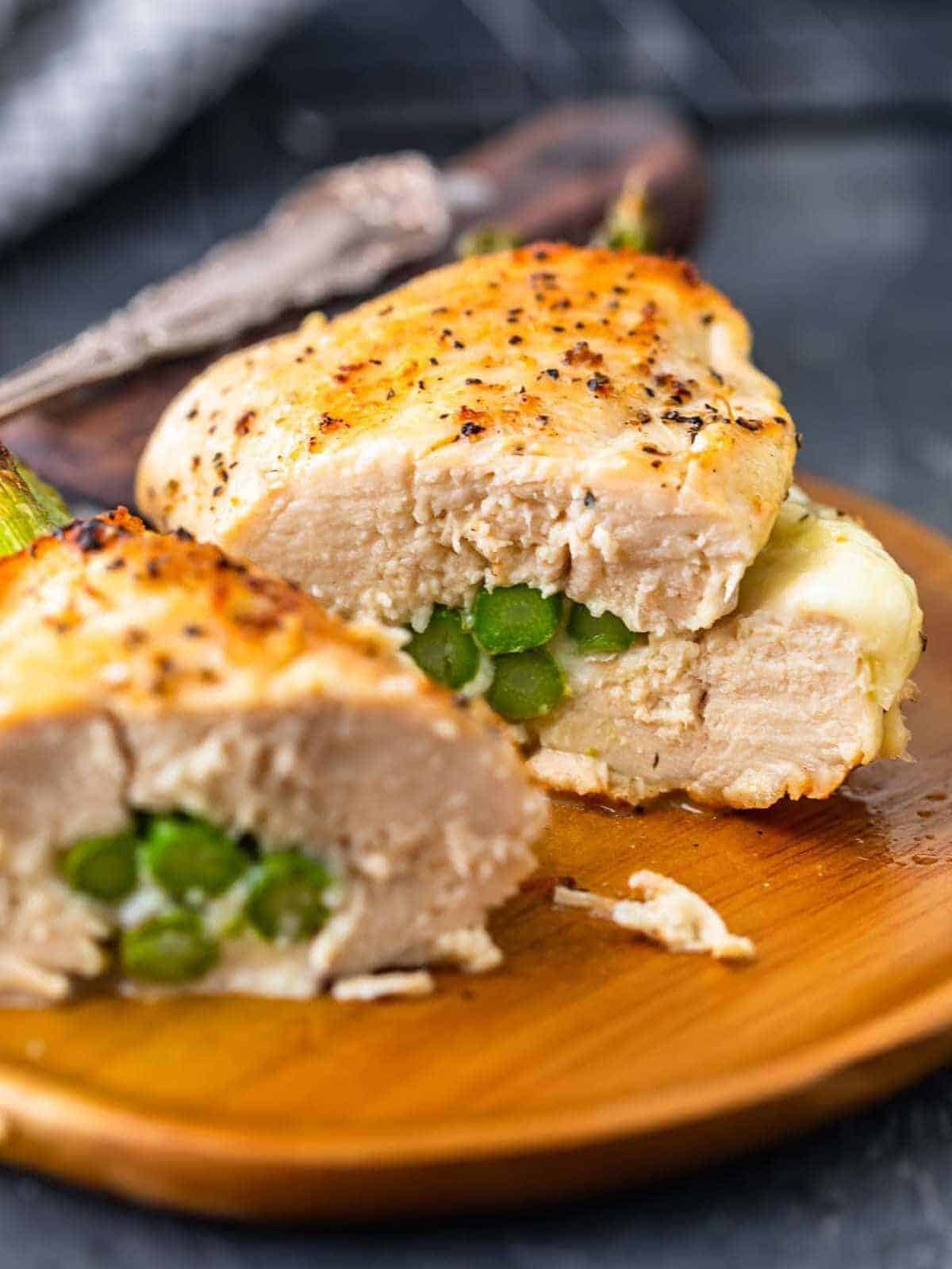 Cut Cheesy Asparagus Stuffed Chicken Breast on a plate