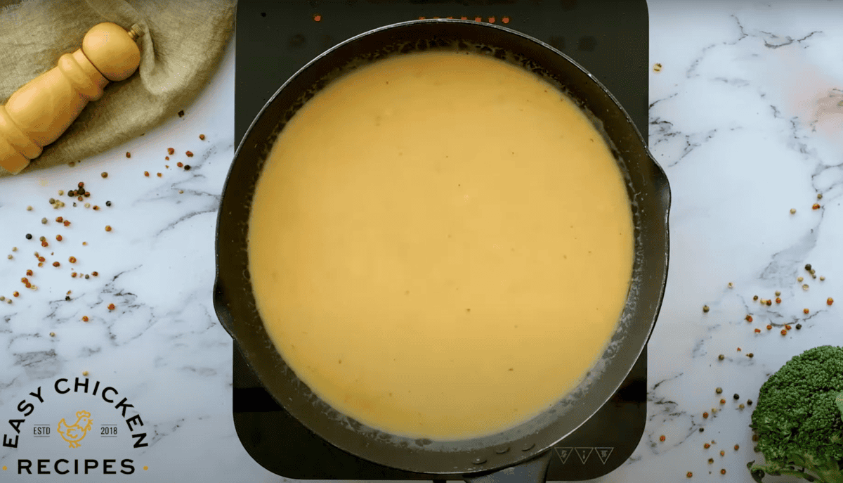 creamy yellow sauce in a cast iron skillet.