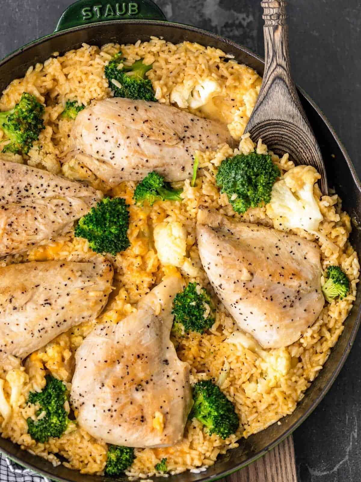 One Pot Cheesy Chicken and Rice with broccoli and cauliflower in skillet