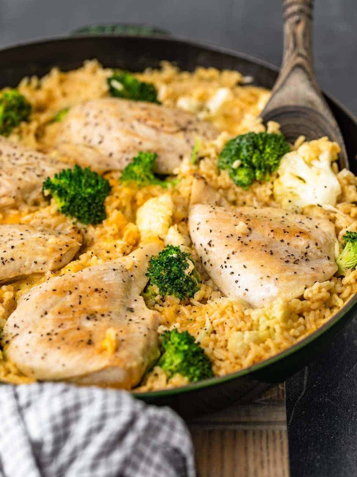 Cheesy Chicken and Rice with veggies in skillet side shot