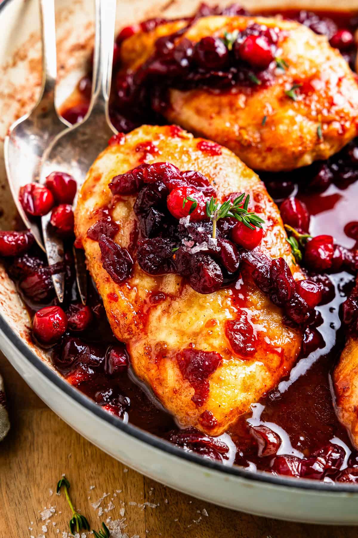 up close cranberry chicken in white skillet