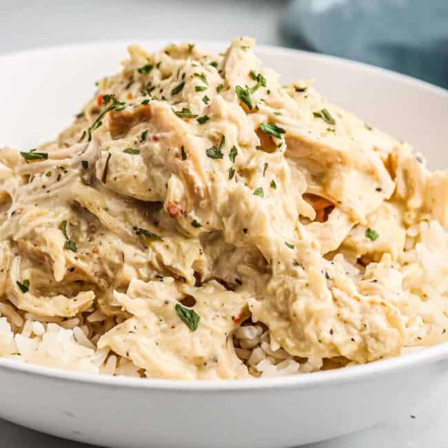 white bowl filled with rice and crockpot italian chicken