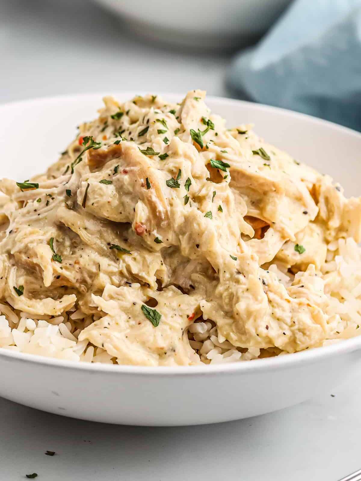 white bowl filled with rice and crockpot italian chicken