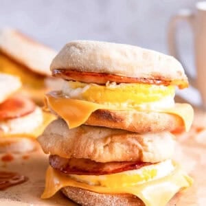 side view of two stacked egg mcmuffins on parchment.