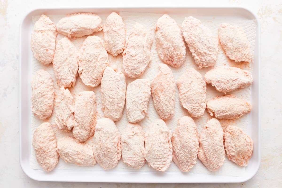 Frozen chicken breasts on a baking sheet.