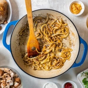 A pan with onions, mushrooms, tomatoes and other ingredients.