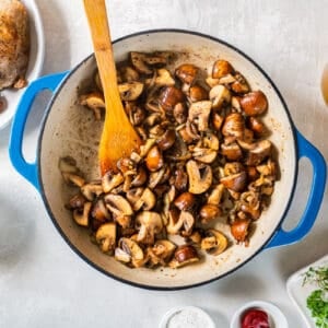 A pan with mushrooms, tomatoes, and other ingredients.