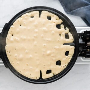 A waffle maker with a pancake in it.