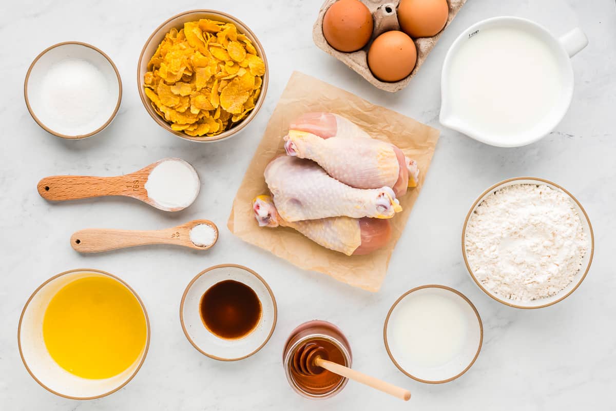 Chicken, eggs, flour and other ingredients on a white background.