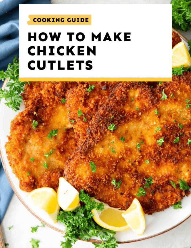 Making chicken cutlets with lemons on a plate.