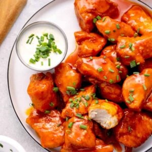 a plate of boneless wings with buffalo sauce