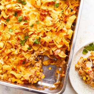 Mexican lasagna in a baking dish with a slice of bread.