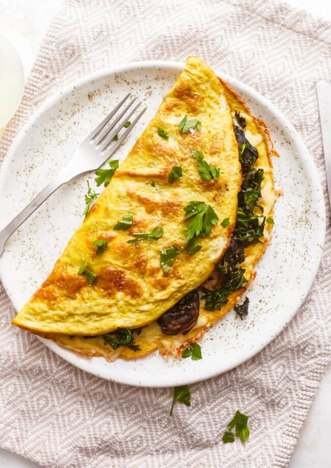 A plate with an omelet on it.