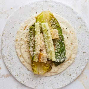 A plate topped with a tortilla and vegetables.
