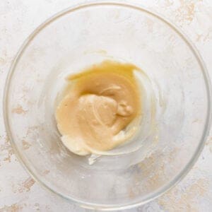 A roux is in a glass bowl.