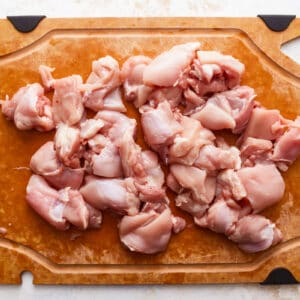Raw chicken on a cutting board.