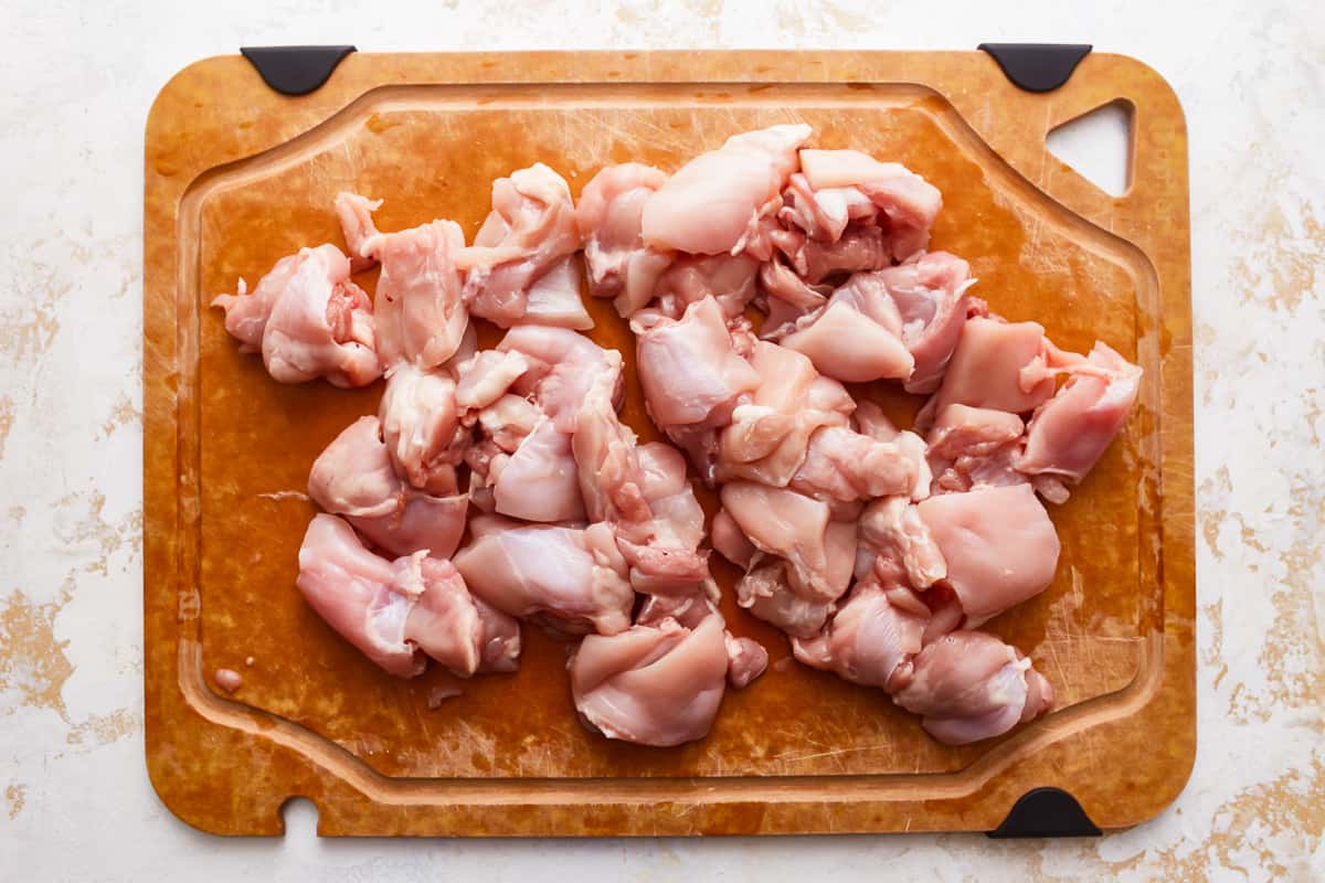 Raw chicken on a cutting board.