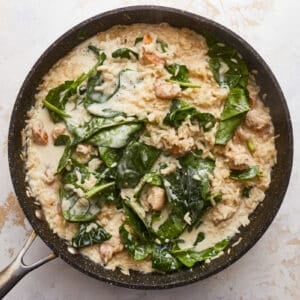 A skillet filled with rice and spinach.