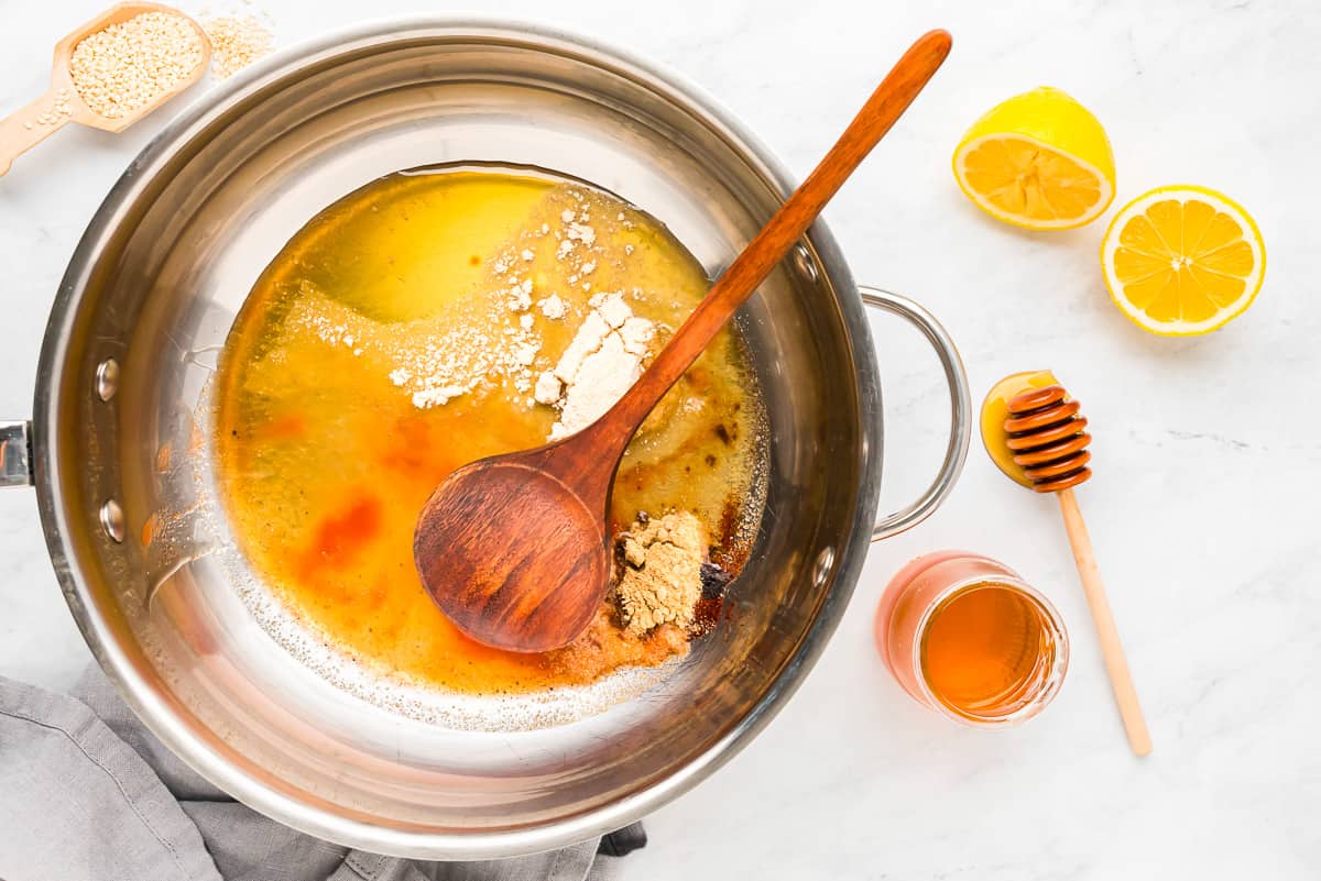 A pot with lemons, honey and other ingredients.