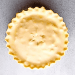 a sealed chicken pot pie in a pie pan.