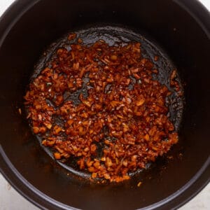 A black pot filled with red chilies.