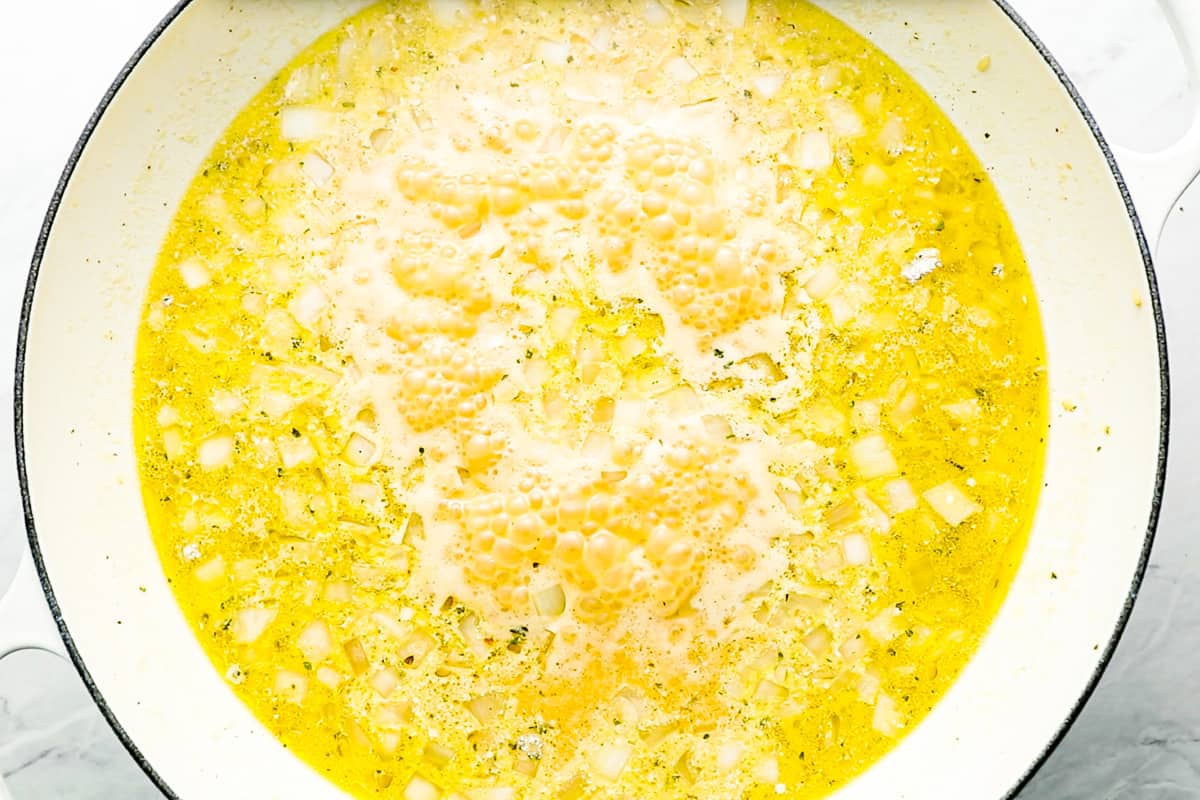 A yellow soup in a pan on a table.