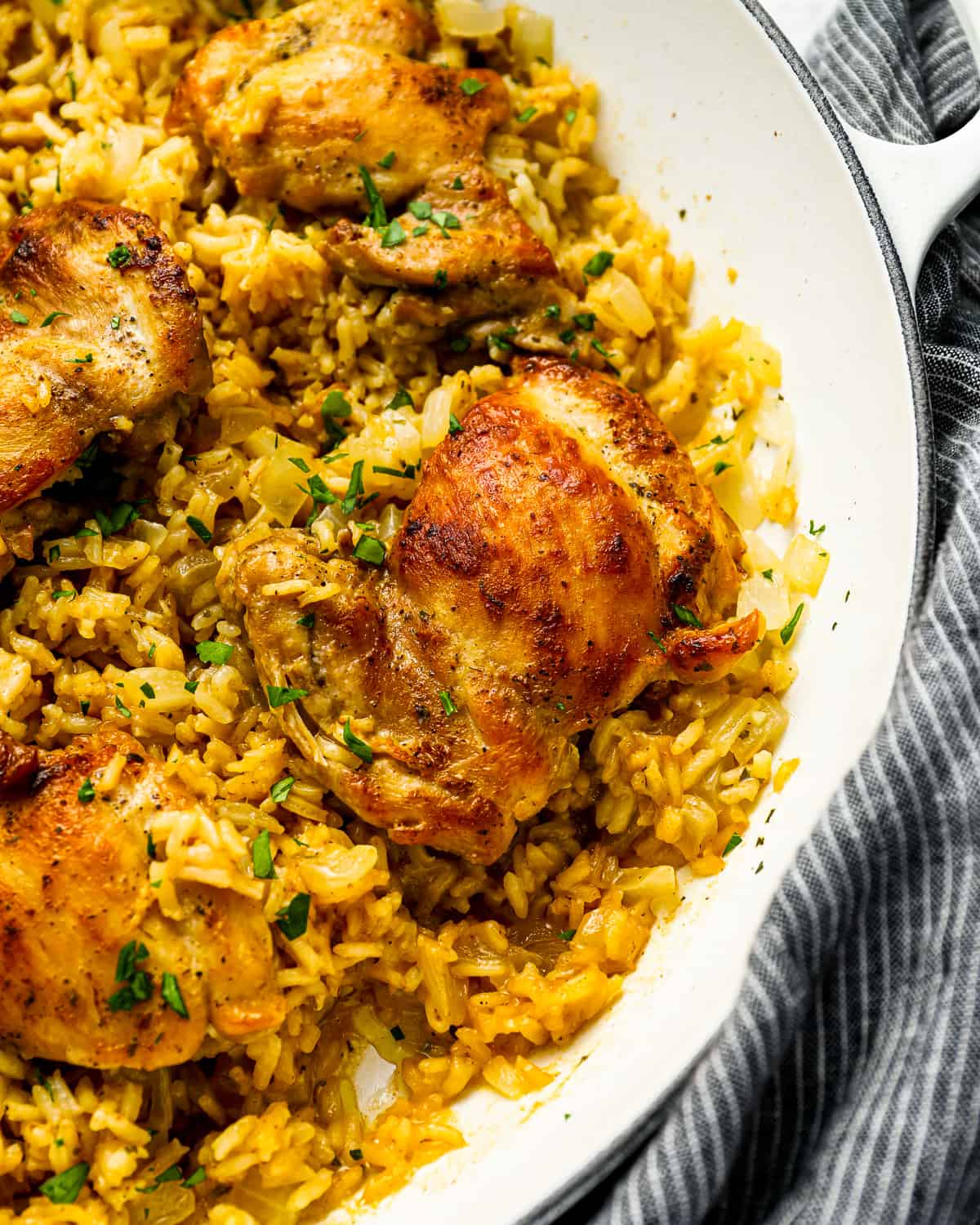 Chicken and rice in a skillet.