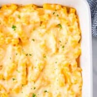 Cheesy macaroni and cheese baked in a white dish.