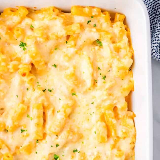 Cheesy macaroni and cheese baked in a white dish.
